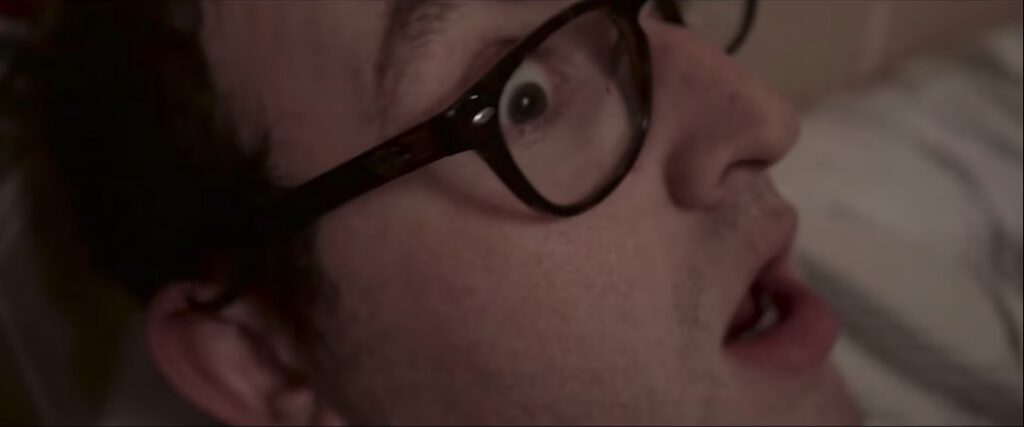 an astonished man with glasses