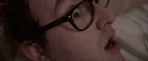 an astonished man with glasses