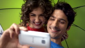 smiling couple takes selfie