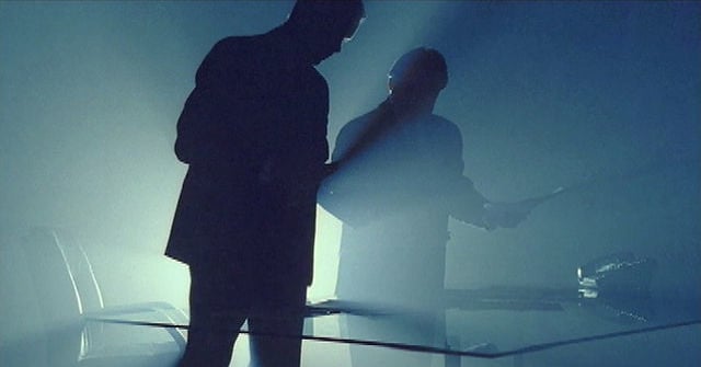 two men backlit