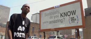 man in front of sign