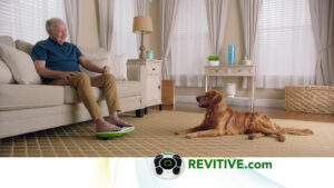 man relaxes on couch by dog